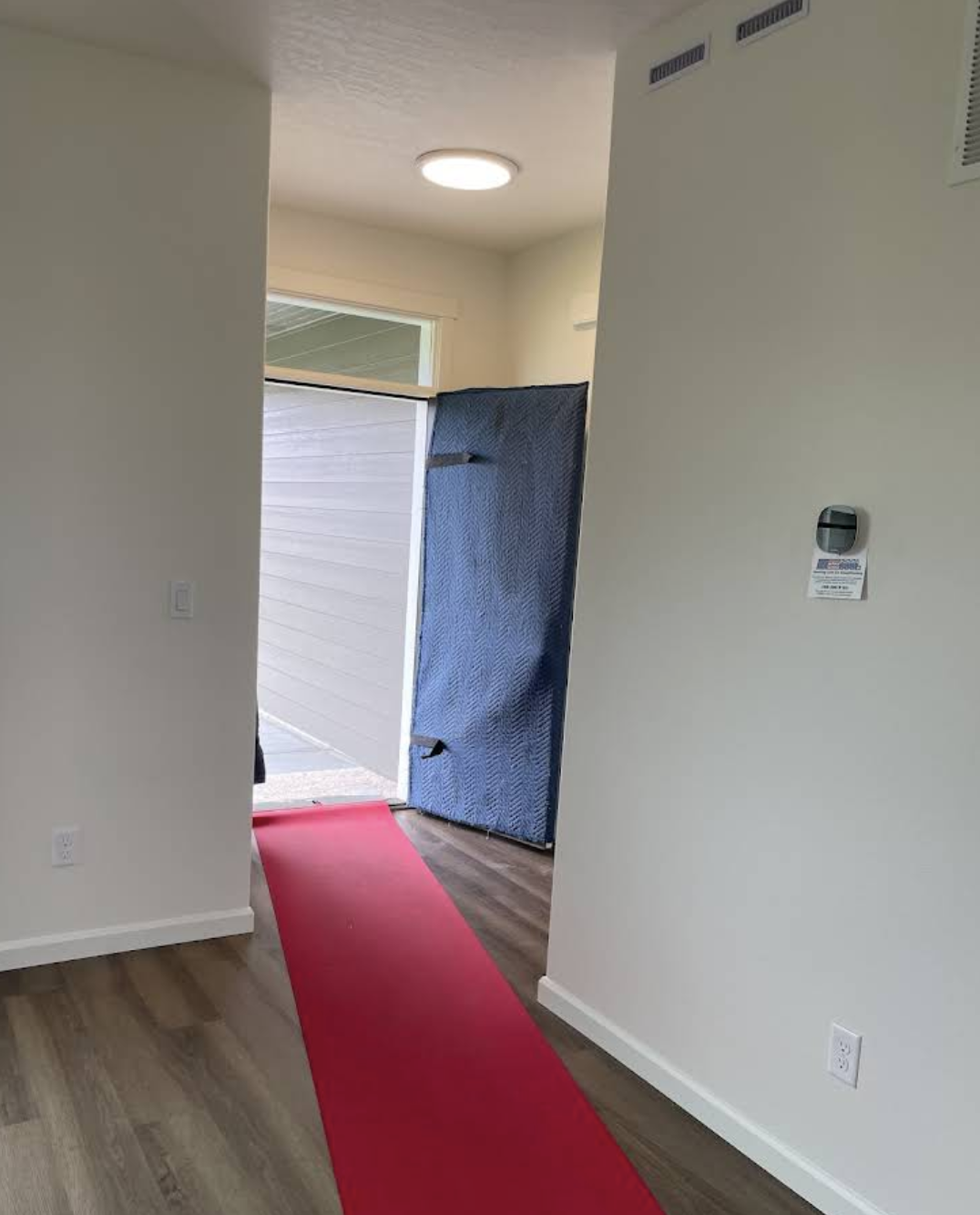 Protective floor runner and door padding set up inside a customer's home before moving begins