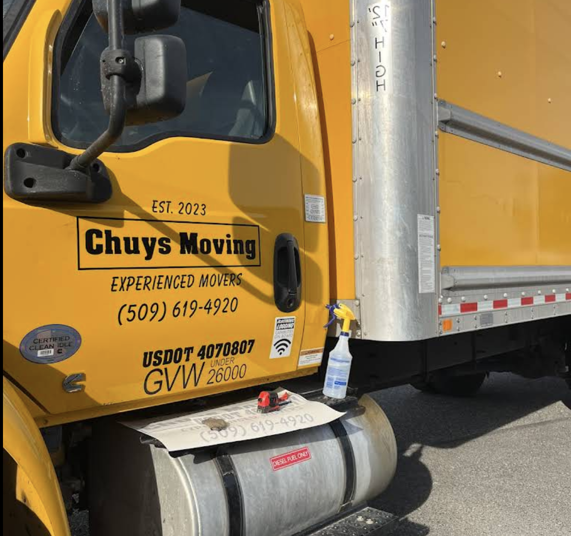 Close-up of Chuy's Moving branded truck with company phone number