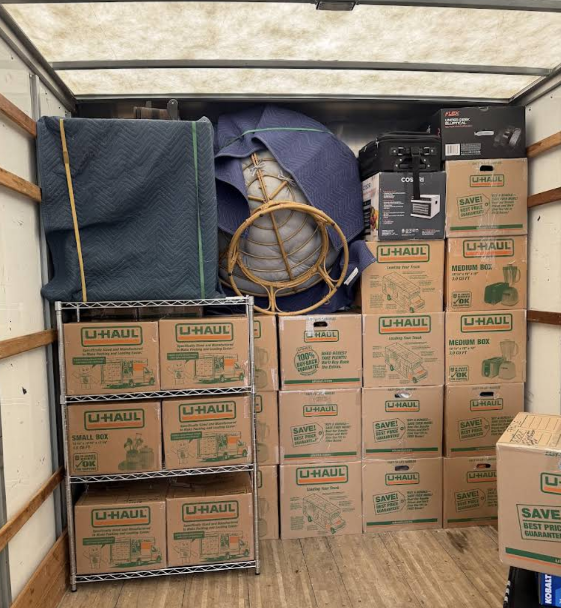 A carefully packed moving truck loaded with organized boxes and protected items
